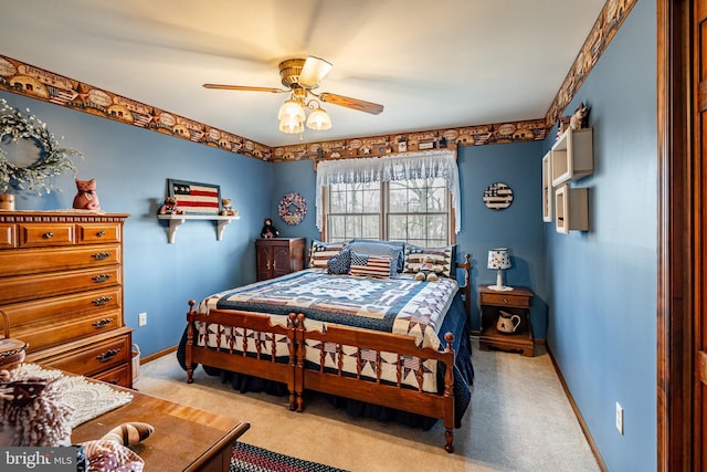 carpeted bedroom featuring ceiling fan and baseboards