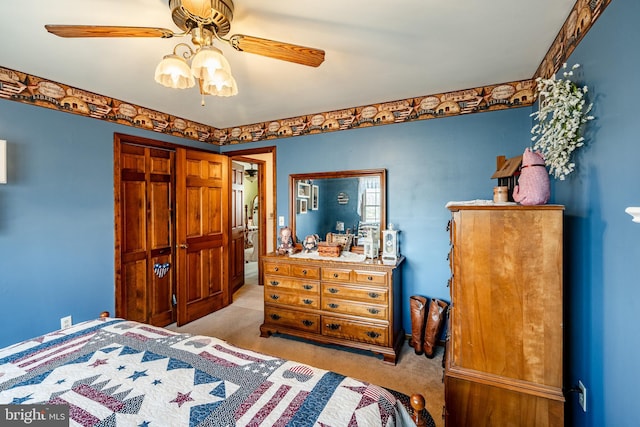 bedroom with light carpet, ceiling fan, and a closet