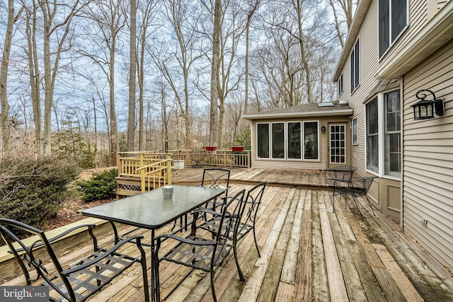 wooden terrace featuring outdoor dining area