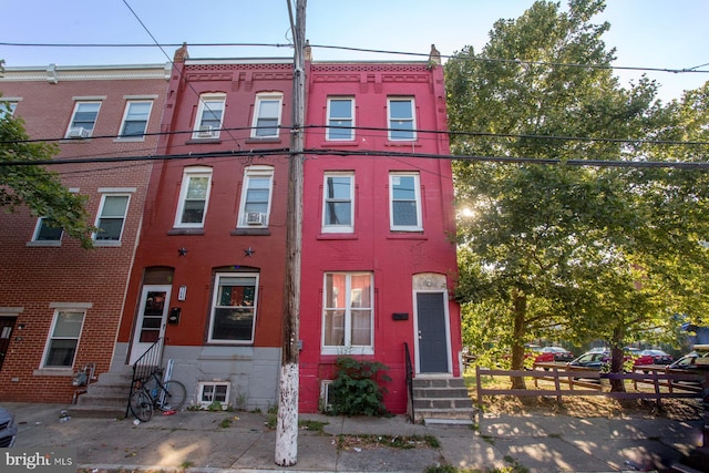 townhome / multi-family property featuring entry steps and brick siding