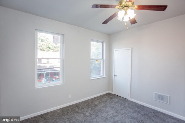 empty room featuring baseboards, visible vents, ceiling fan, and carpet flooring