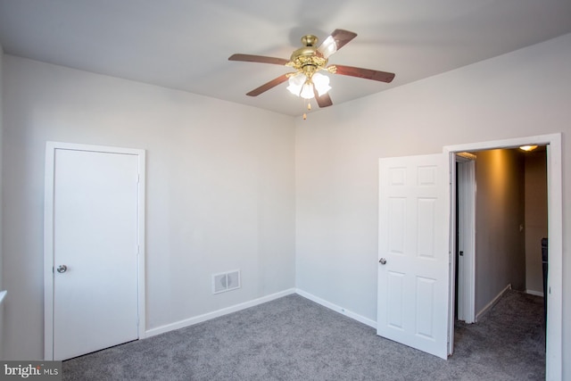 empty room featuring carpet flooring, ceiling fan, visible vents, and baseboards