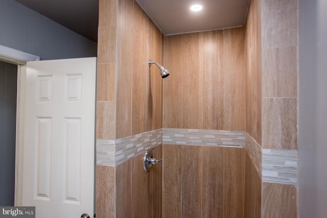 interior details featuring tiled shower