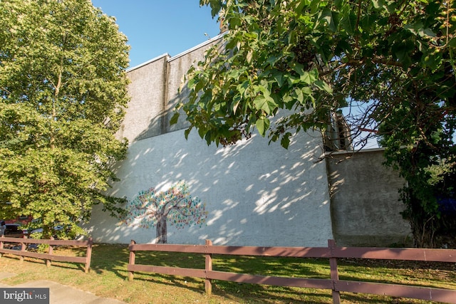 view of home's exterior featuring fence and stucco siding