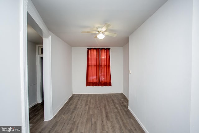 spare room with ceiling fan, baseboards, and wood finished floors