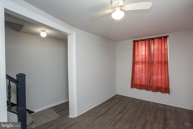 unfurnished room with a ceiling fan, baseboards, and wood finished floors