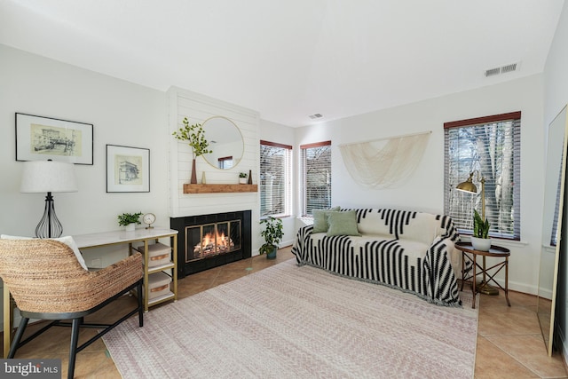 interior space featuring a large fireplace, baseboards, and visible vents