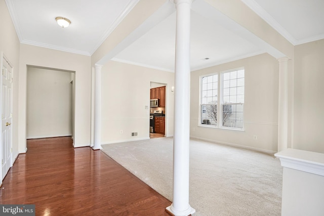 interior space with decorative columns, crown molding, visible vents, and carpet flooring