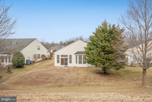 rear view of property featuring a yard