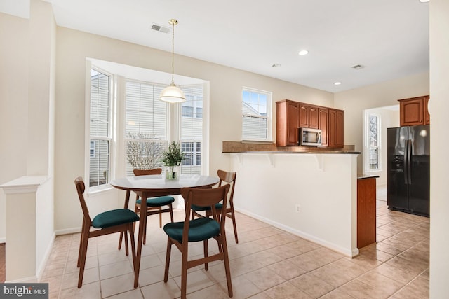 dining room featuring light tile patterned floors, baseboards, visible vents, and recessed lighting