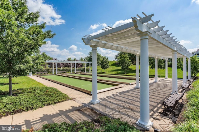 view of home's community with a pergola and a yard