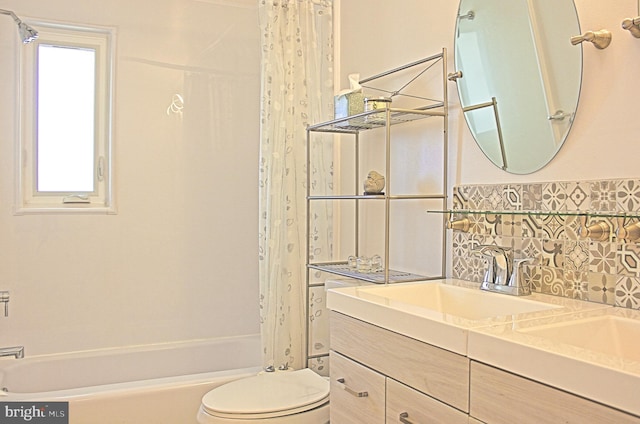 full bath featuring toilet, shower / bath combo with shower curtain, decorative backsplash, and vanity