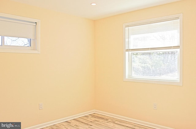 unfurnished room featuring light wood-style floors, recessed lighting, and baseboards