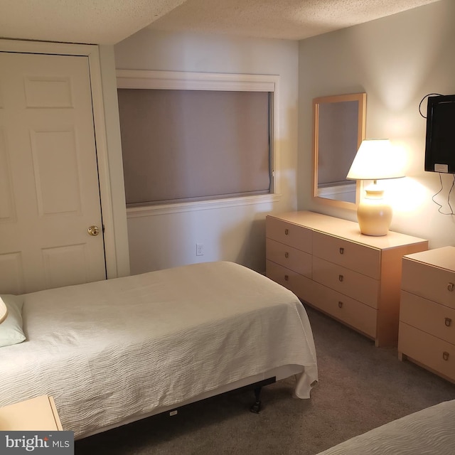 carpeted bedroom with a textured ceiling