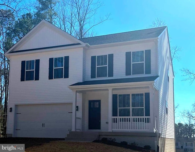 view of front of property featuring covered porch and a garage