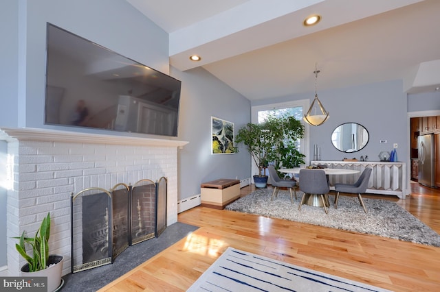 living room with a baseboard heating unit, recessed lighting, and wood finished floors