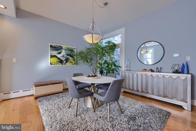 dining area featuring a baseboard heating unit, recessed lighting, and wood finished floors