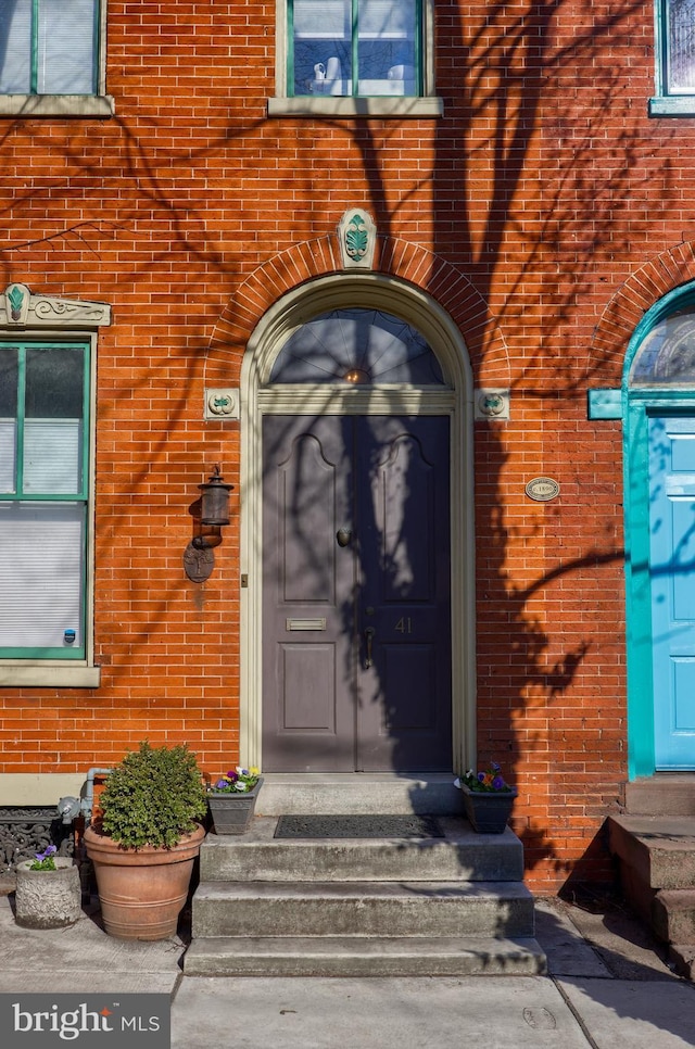 property entrance with brick siding