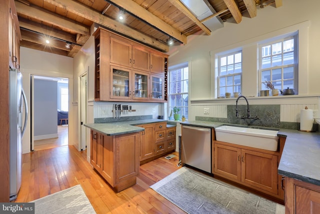 kitchen with light wood-type flooring, brown cabinets, a sink, stainless steel appliances, and wood ceiling