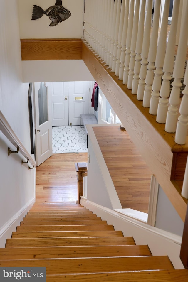 stairs featuring hardwood / wood-style flooring