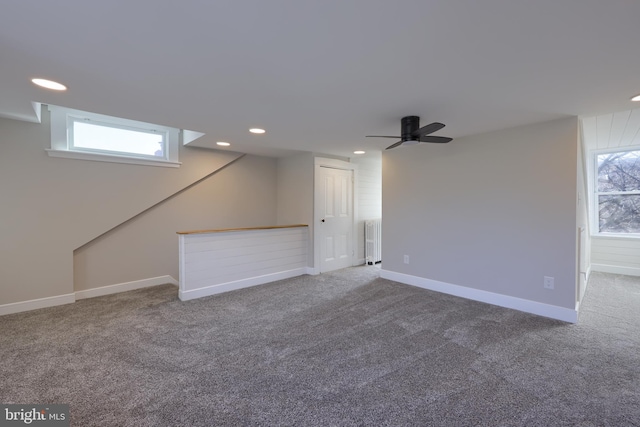 interior space featuring a ceiling fan, baseboards, radiator heating unit, recessed lighting, and carpet flooring