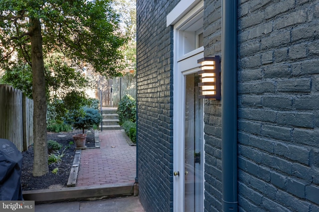 view of patio / terrace with a grill and fence