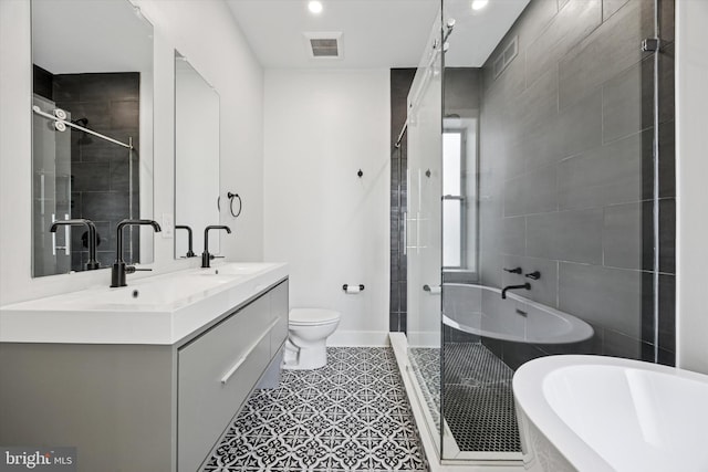 full bath with toilet, a sink, visible vents, double vanity, and a stall shower