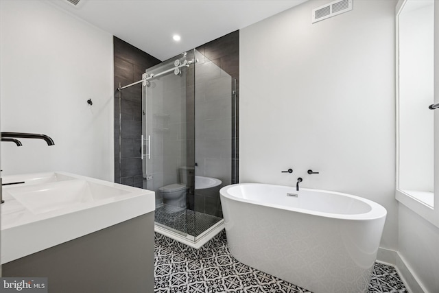 bathroom with visible vents, baseboards, tile patterned floors, a freestanding tub, and a shower stall