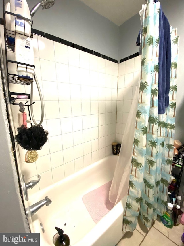 bathroom with shower / bath combination with curtain and tile patterned floors