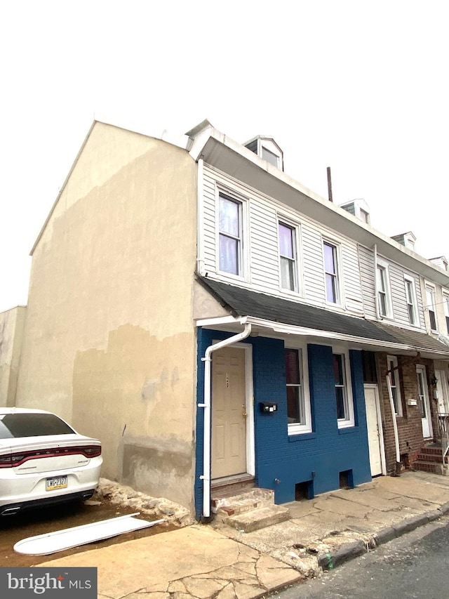 view of property with entry steps and brick siding