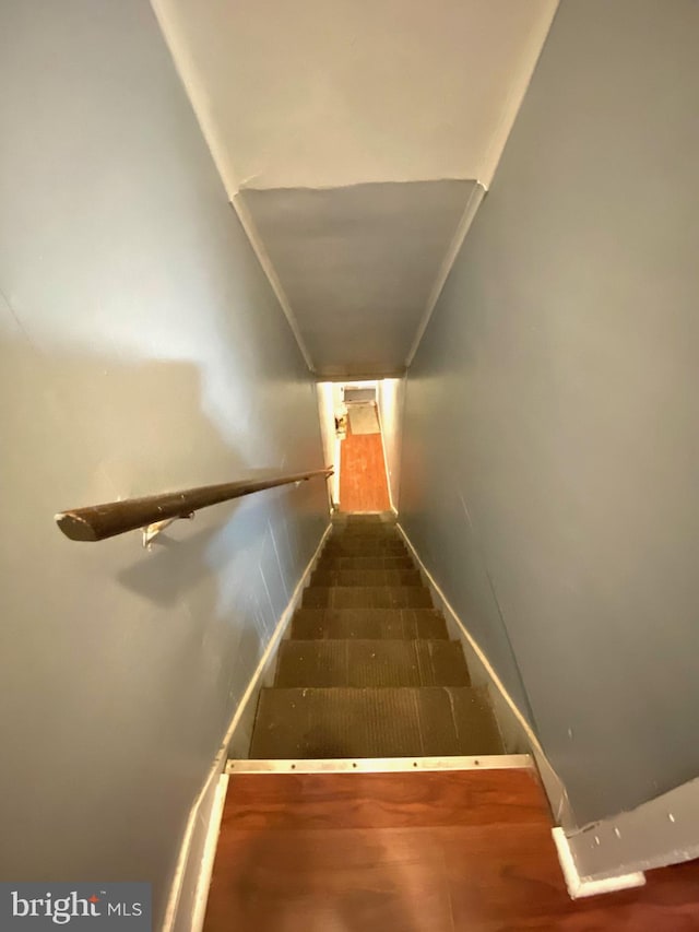 stairs featuring crown molding