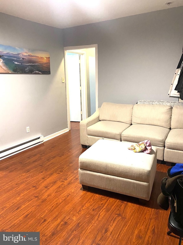 living room featuring baseboard heating, wood finished floors, and baseboards