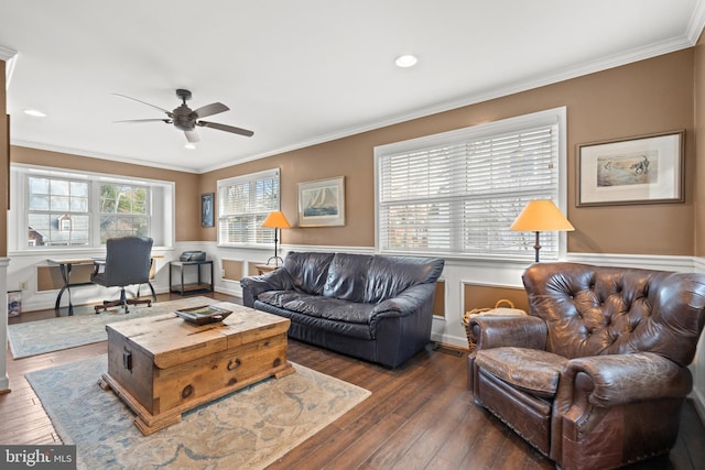 living area featuring ornamental molding, ceiling fan, baseboards, and hardwood / wood-style flooring