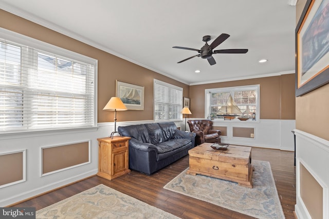 living area featuring a healthy amount of sunlight, wood finished floors, and wainscoting