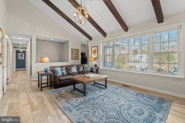 living room with beam ceiling, a notable chandelier, light wood finished floors, visible vents, and baseboards