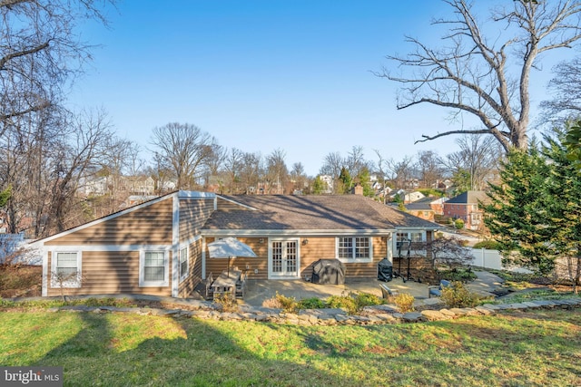 back of property with french doors, a yard, a patio, a chimney, and fence