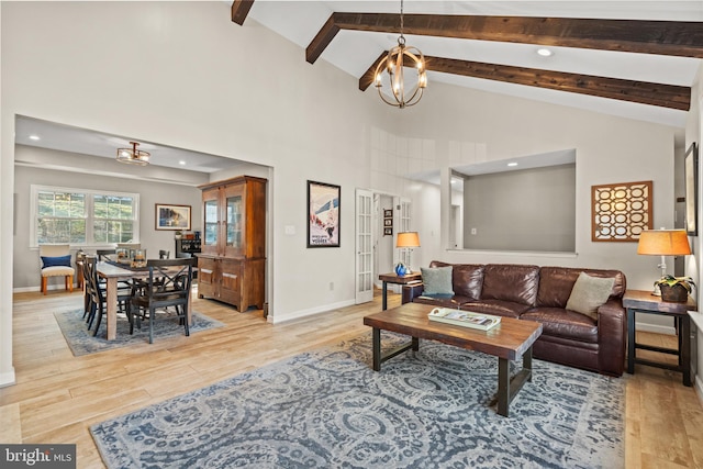 living room with light wood-style flooring, beam ceiling, and a notable chandelier