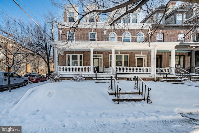 multi unit property with covered porch and brick siding