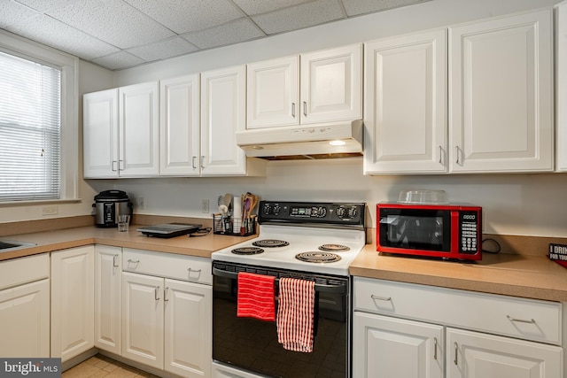 kitchen featuring range with electric cooktop, white cabinetry, a paneled ceiling, and under cabinet range hood