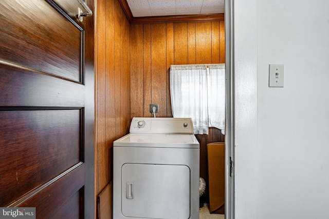 laundry area featuring washer / dryer, laundry area, and wood walls