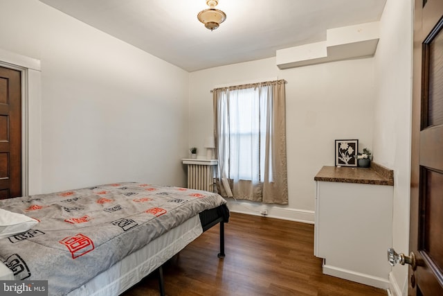 bedroom featuring dark wood-style flooring and baseboards