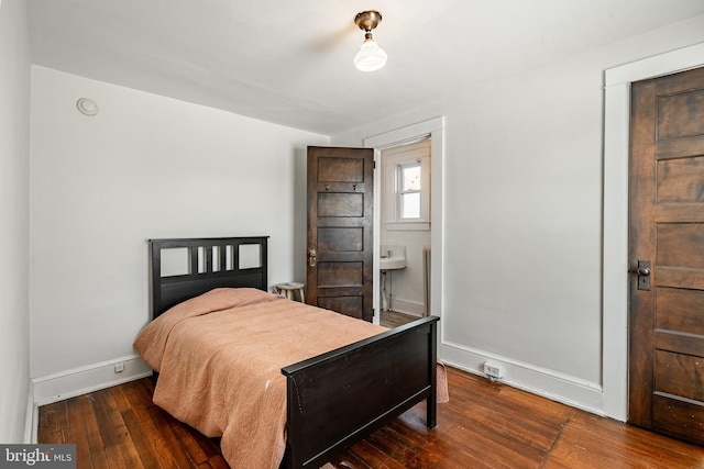 bedroom with hardwood / wood-style floors and baseboards