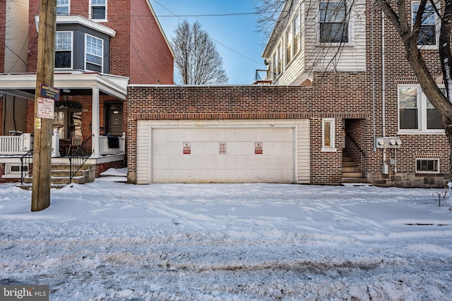 view of front facade with a garage and brick siding