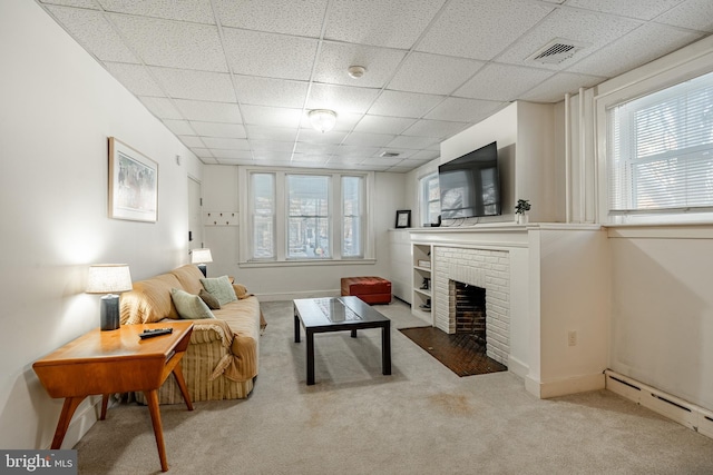 carpeted living room with baseboards, visible vents, baseboard heating, a paneled ceiling, and a brick fireplace