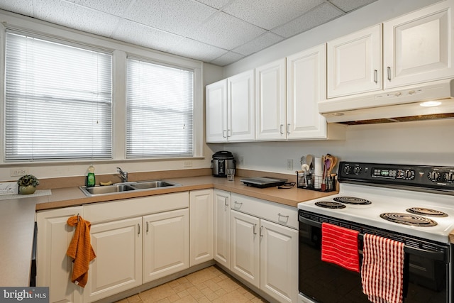 kitchen with range with electric cooktop, white cabinetry, a sink, and under cabinet range hood