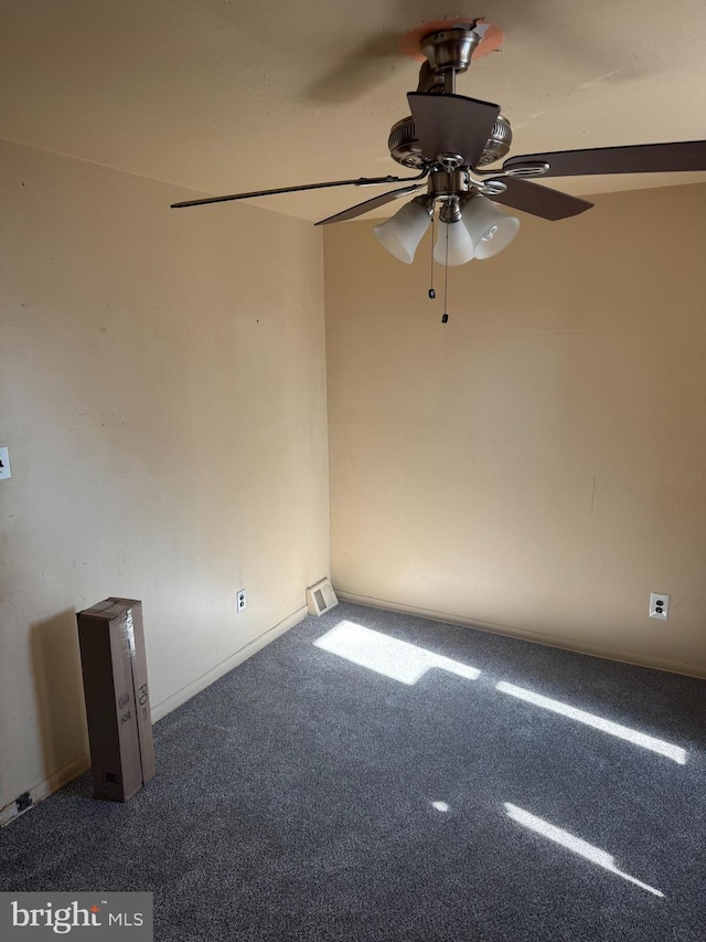 carpeted spare room with a ceiling fan