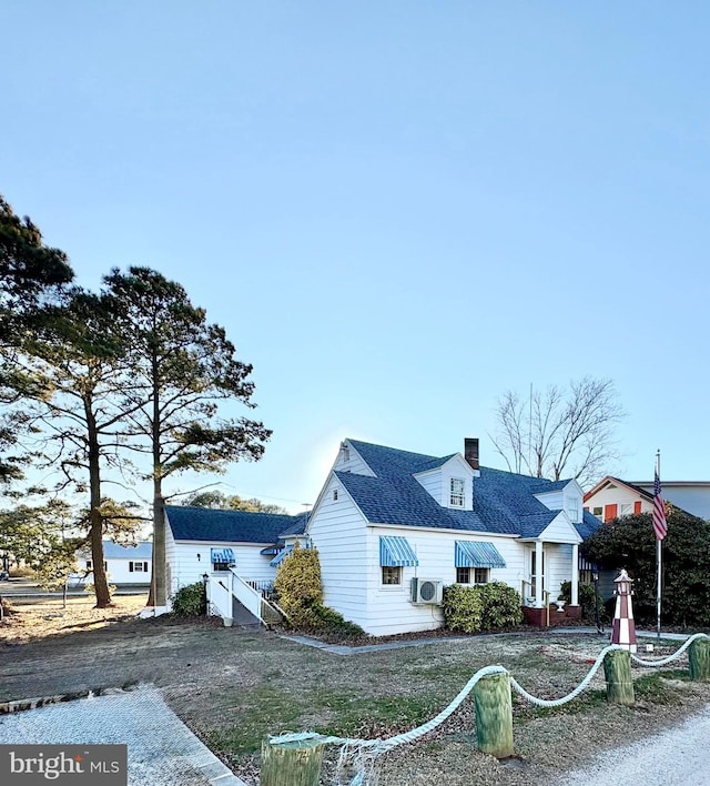 view of front of home featuring roof with shingles and a chimney