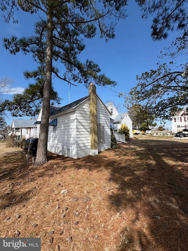 view of property exterior featuring a chimney