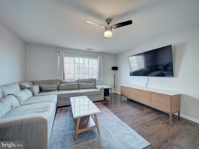 living room featuring ceiling fan, dark wood-type flooring, visible vents, and baseboards