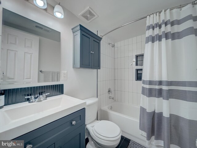 full bath with toilet, visible vents, shower / tub combo with curtain, and vanity